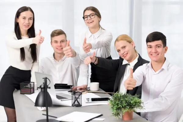 group of six professionals giving thumbs up