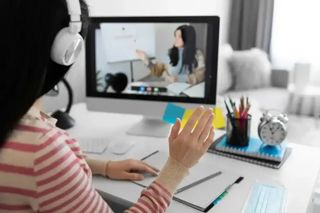 person wearing headphones interacts during an online lesson