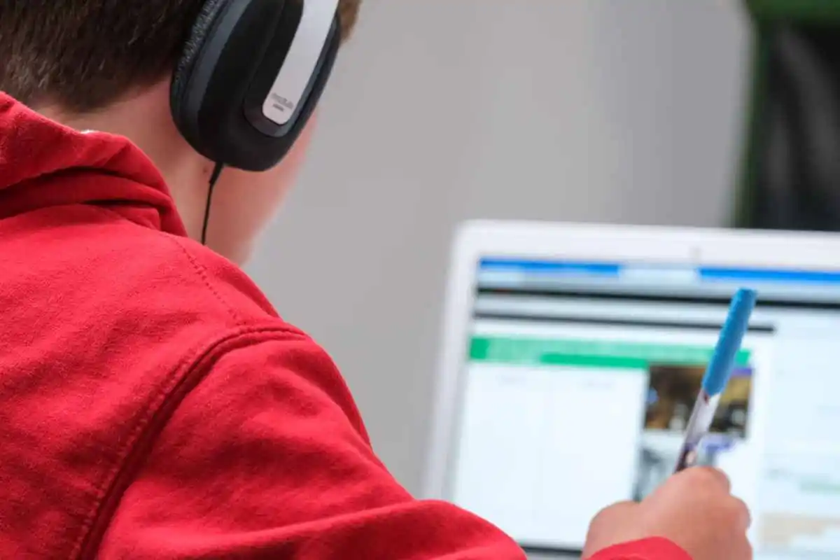 boy studying on school work with laptop