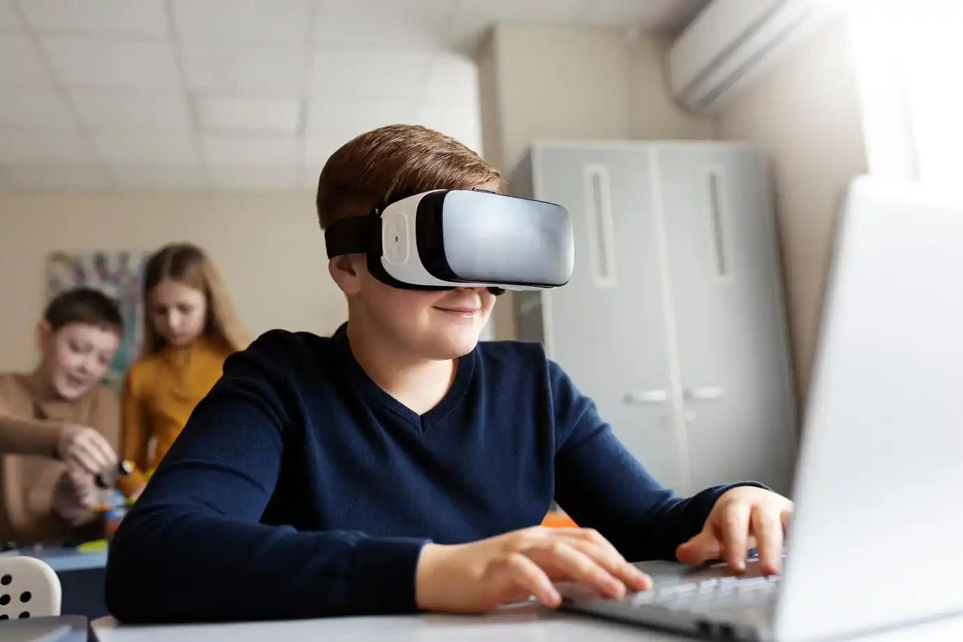 boy using a laptop and vr glasses