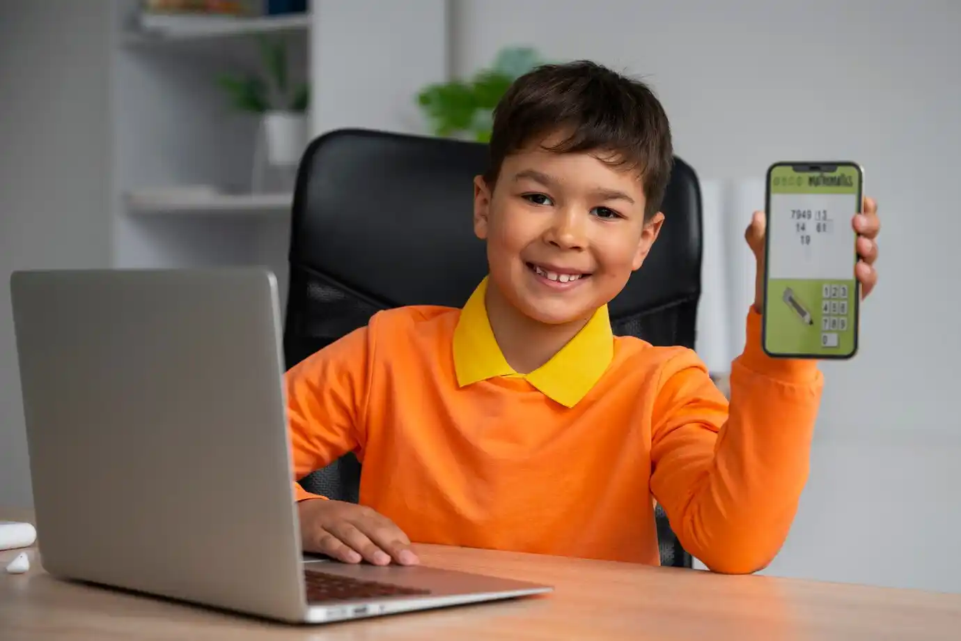 child in an shirt holds a smartphone displaying a app