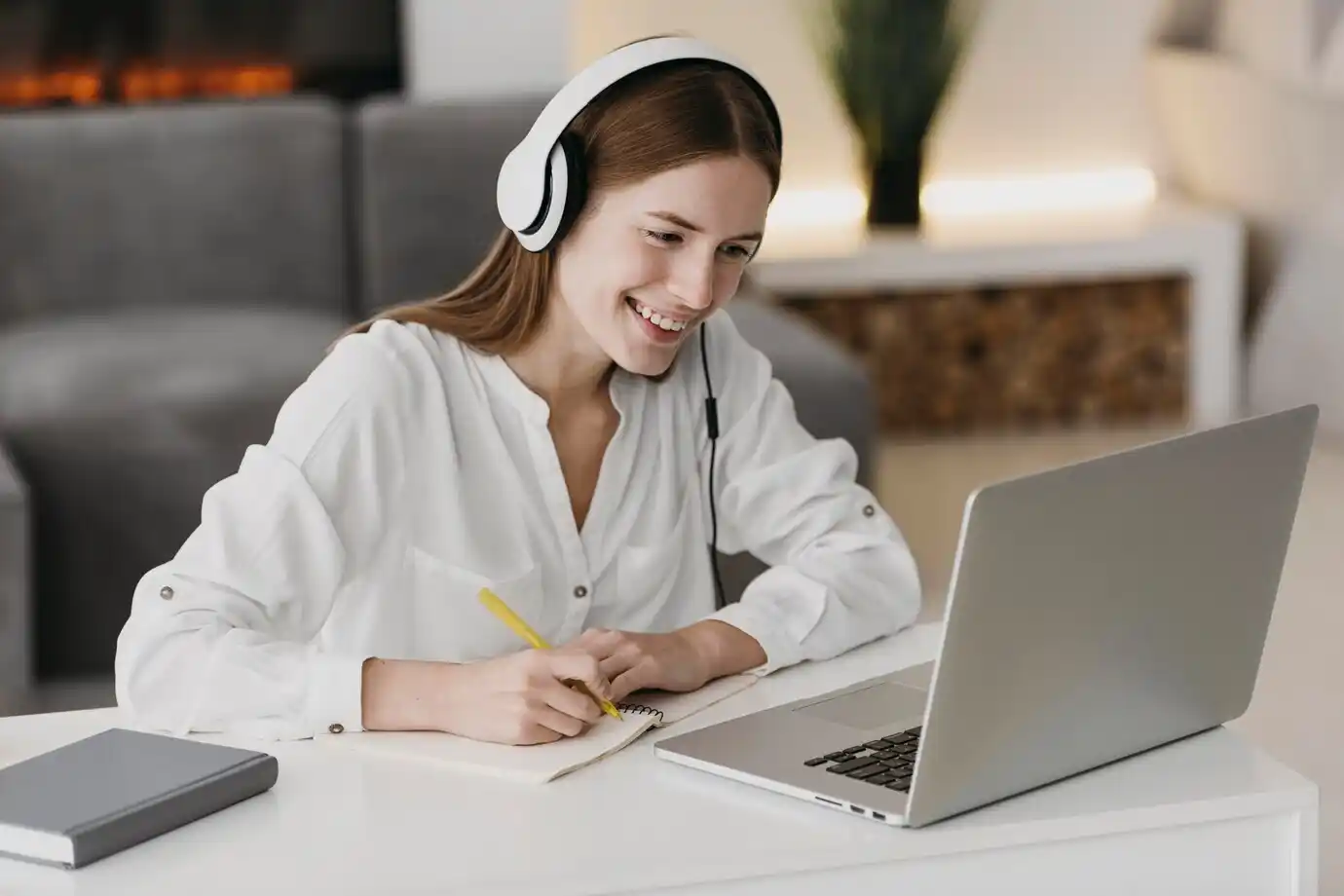 person in a white shirt wears headphones