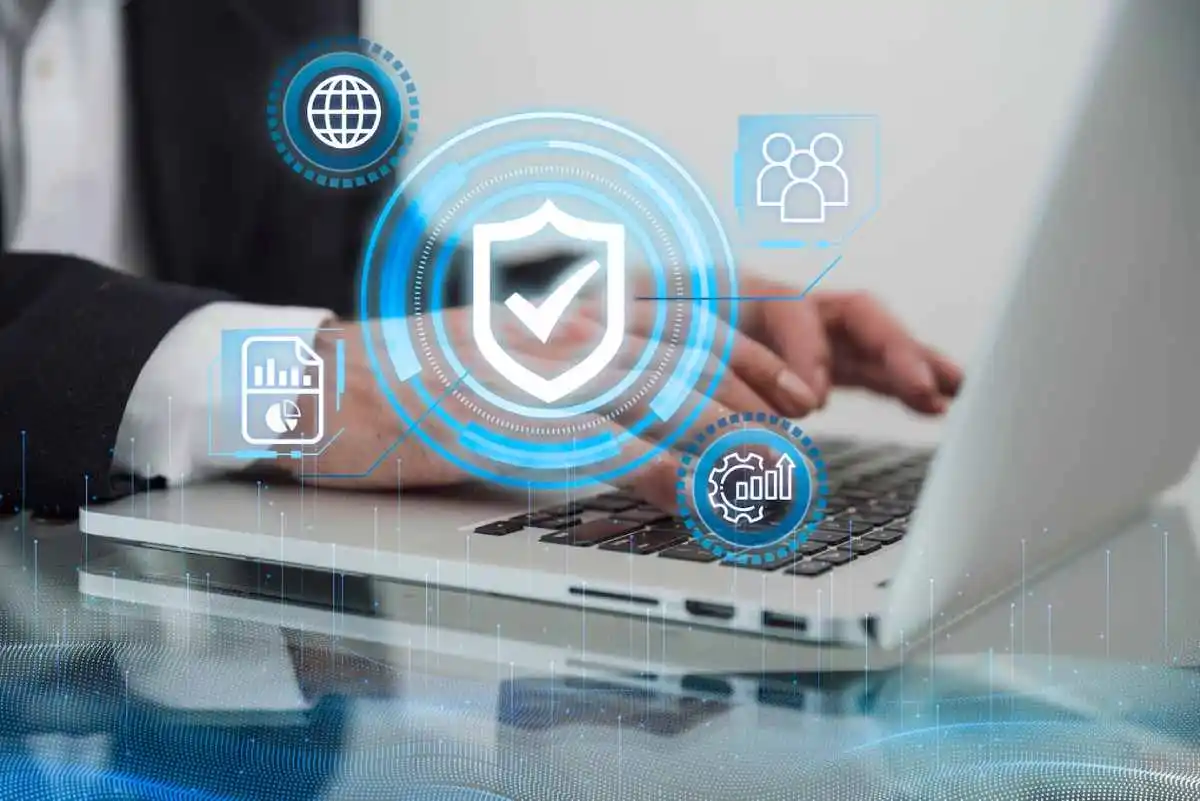business professional typing on a laptop, surrounded by digital security